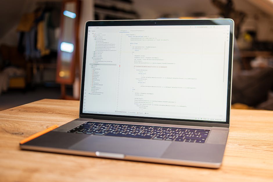 In the image, there is a close-up view of a computer screen displaying lines of programming code with syntax highlighting. The code includes various elements such as functions, variables, and conditio